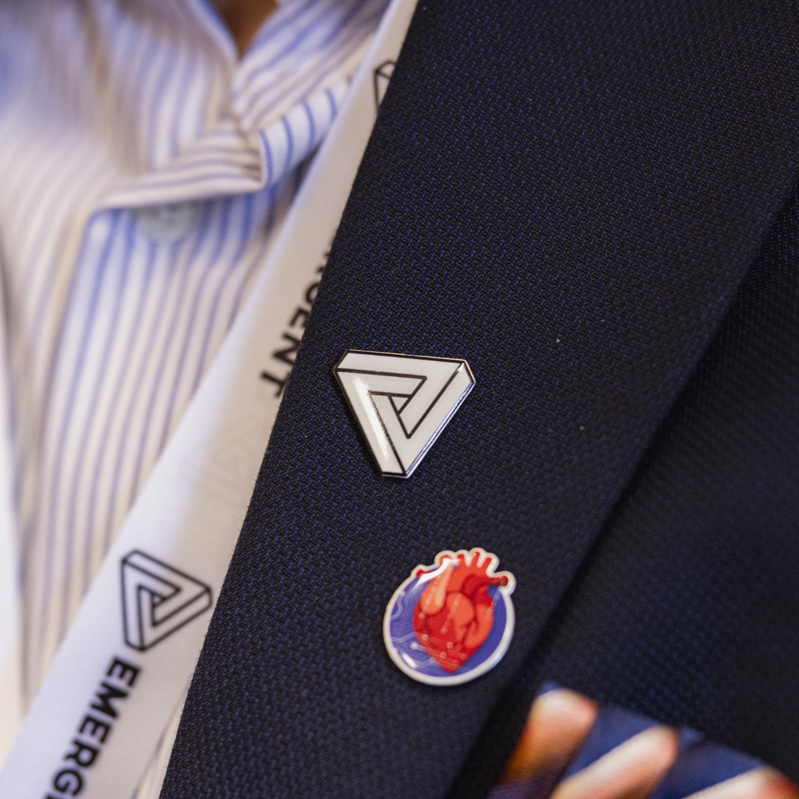 Emergent members wearing pins and event lanyards
