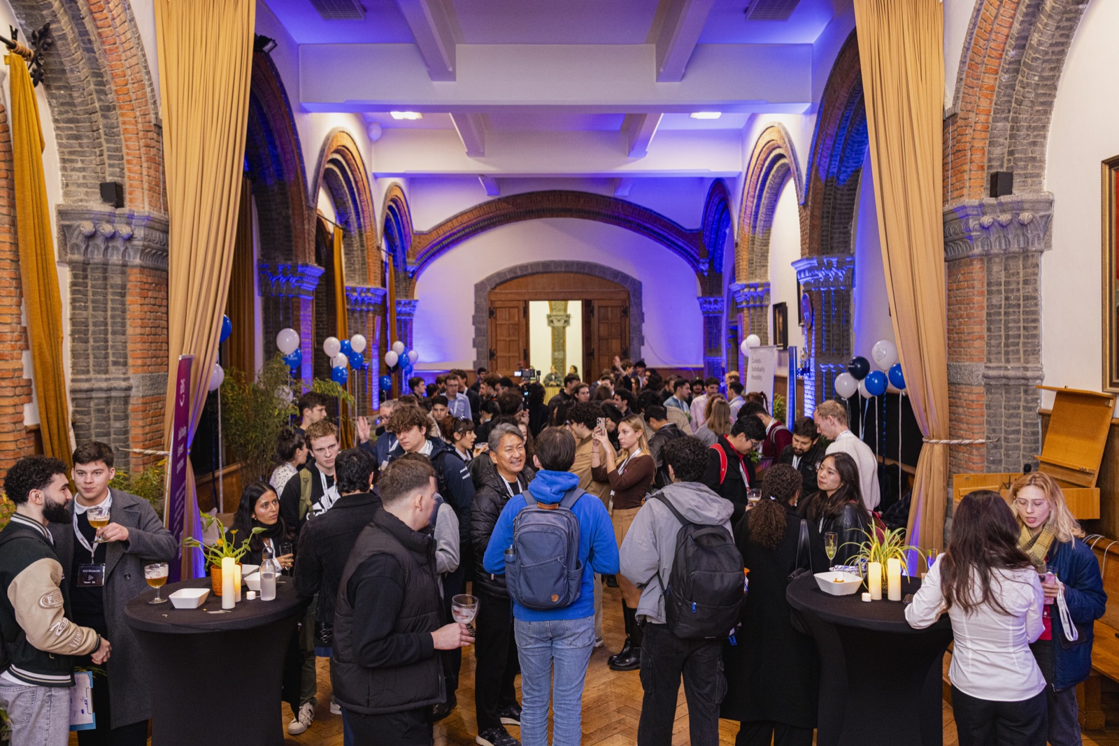 A busy Emergent networking reception in a university hall